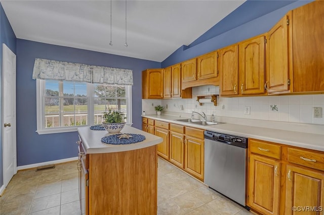 kitchen with visible vents, a sink, stainless steel dishwasher, light countertops, and vaulted ceiling