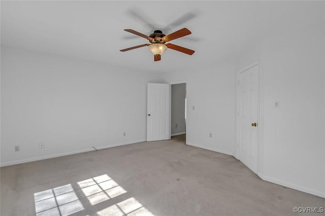 unfurnished bedroom featuring carpet flooring, a ceiling fan, and baseboards