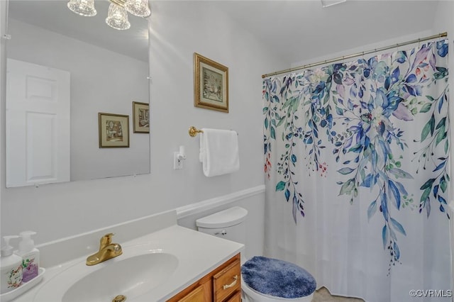 full bathroom with toilet, vanity, and a shower with curtain