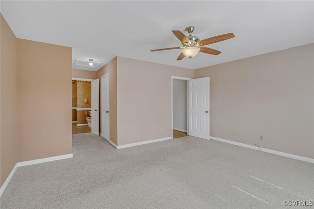 unfurnished room with attic access, light colored carpet, baseboards, and ceiling fan