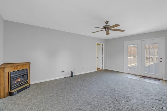 unfurnished living room with a glass covered fireplace, ceiling fan, baseboards, and carpet floors