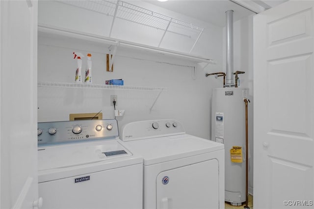 laundry area featuring water heater, laundry area, and independent washer and dryer