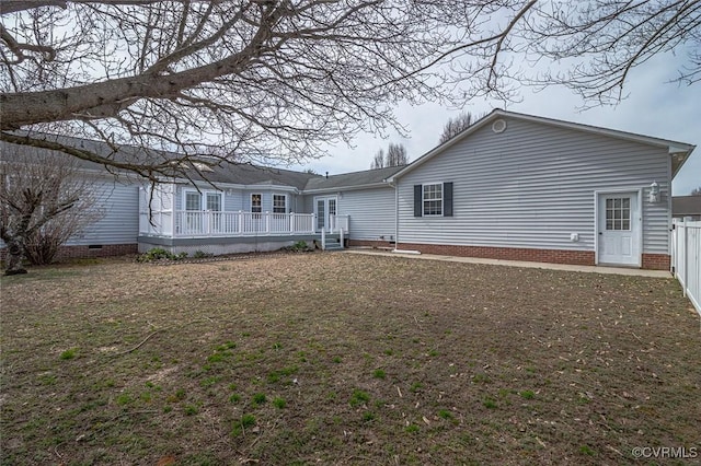 back of property featuring a wooden deck, fence, and crawl space