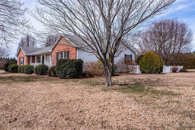 view of home's exterior with a lawn and brick siding