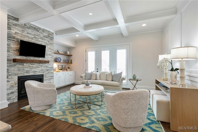 living room with dark wood-style floors, a fireplace, baseboards, and beam ceiling