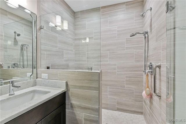 full bathroom with a walk in shower and vanity