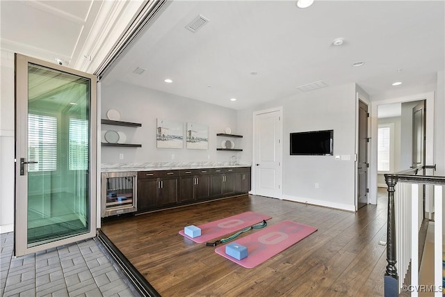 bar with wine cooler, recessed lighting, dark wood-type flooring, visible vents, and baseboards