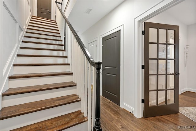 stairway with baseboards and wood finished floors