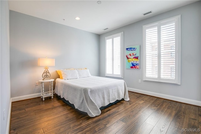 bedroom with recessed lighting, dark wood-style flooring, visible vents, and baseboards