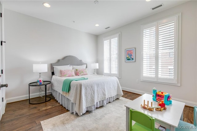 bedroom with dark wood-style floors, recessed lighting, visible vents, and baseboards