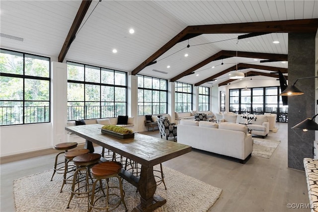 interior space featuring light wood-style floors, recessed lighting, visible vents, and lofted ceiling with beams