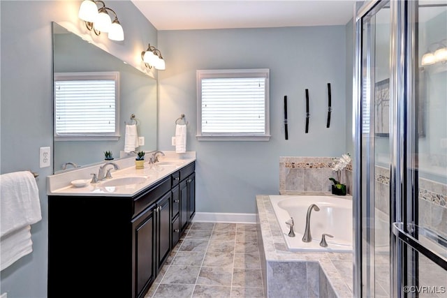 full bathroom with a garden tub, a sink, baseboards, and double vanity