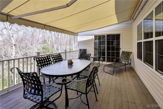 wooden terrace with outdoor dining area