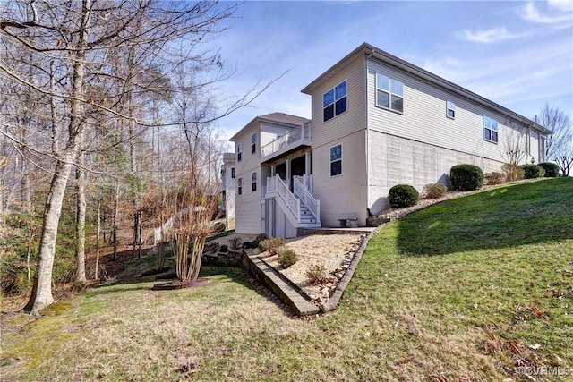 view of property exterior with stairs and a lawn