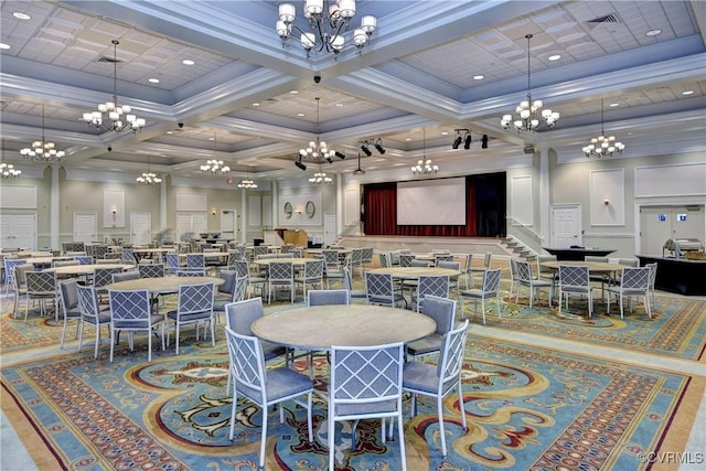 dining space featuring a chandelier, ornamental molding, and a decorative wall