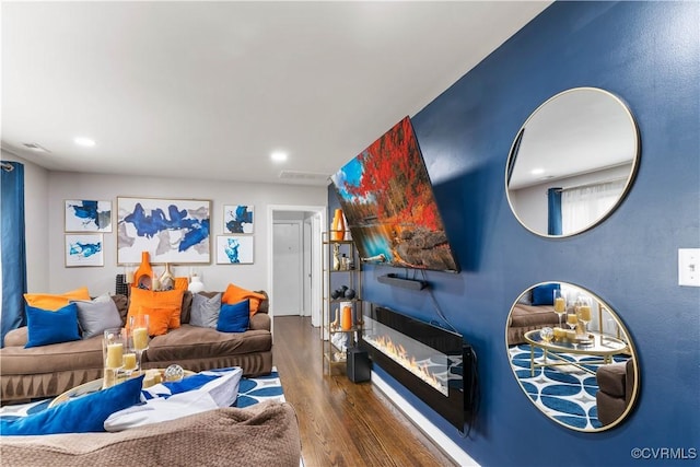 living area featuring dark wood-style floors, recessed lighting, and visible vents