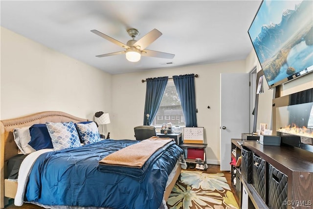 bedroom with light wood finished floors, ceiling fan, and visible vents