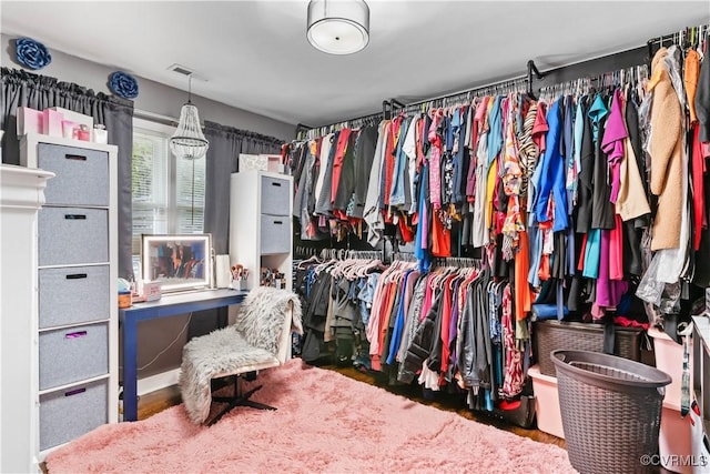 walk in closet featuring visible vents and wood finished floors