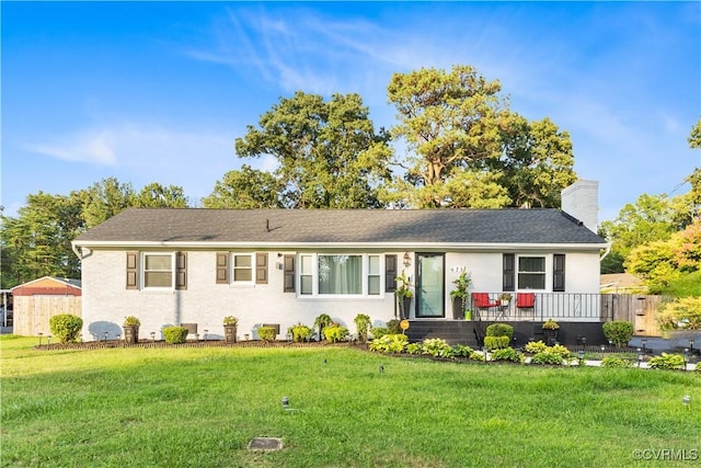 ranch-style home featuring a chimney, fence, and a front lawn