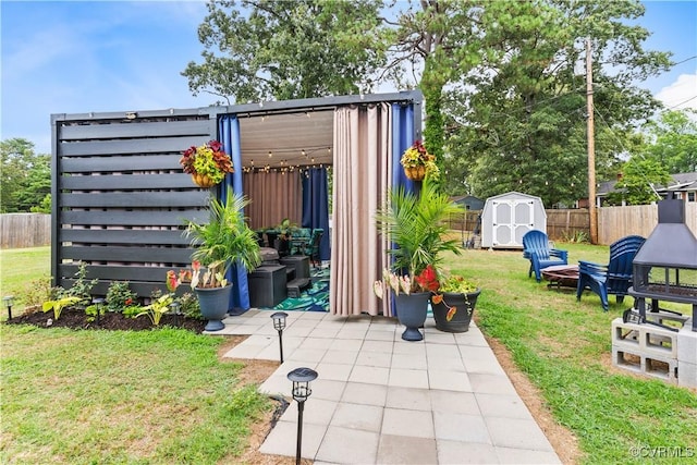 view of shed with an outdoor fire pit and a fenced backyard