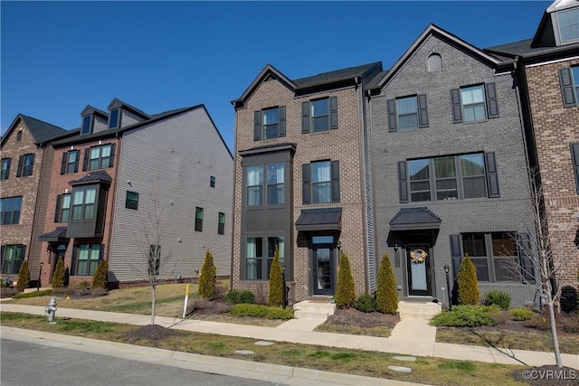 townhome / multi-family property with brick siding