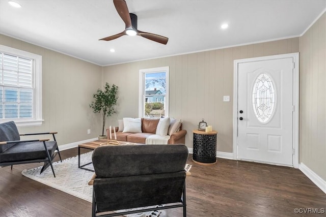 living room featuring baseboards, a ceiling fan, dark wood-style floors, crown molding, and recessed lighting