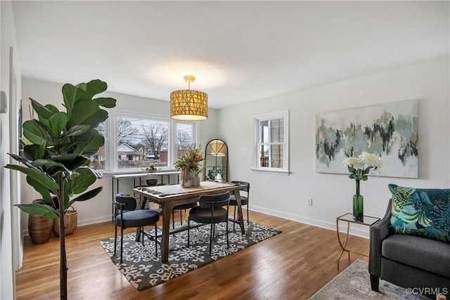 dining space featuring baseboards and light wood-style floors