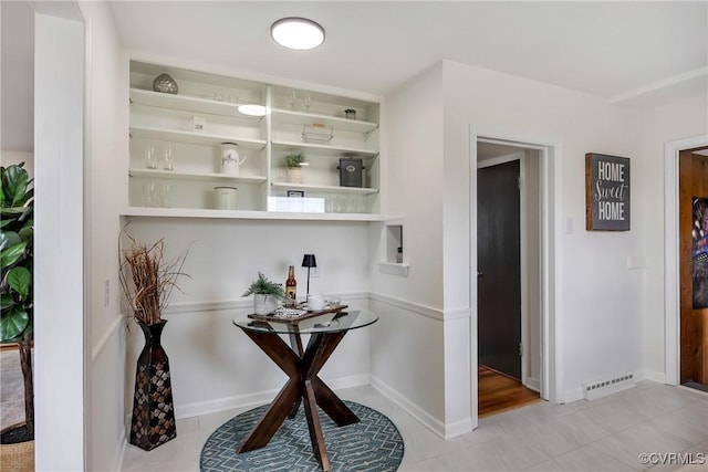 interior space with built in shelves, visible vents, baseboards, and light tile patterned flooring