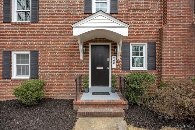 property entrance featuring brick siding