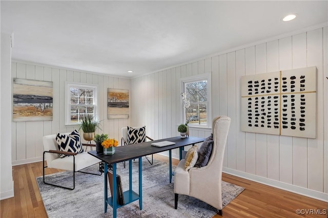 office featuring a healthy amount of sunlight, baseboards, and wood finished floors