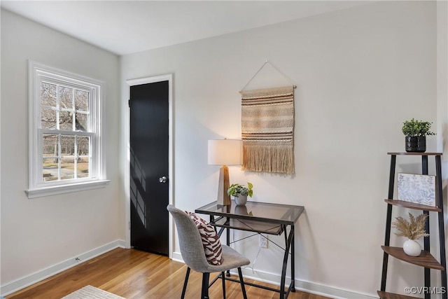 office area with baseboards and wood finished floors