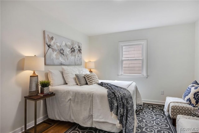 bedroom featuring dark wood finished floors and baseboards