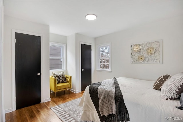 bedroom featuring baseboards and wood finished floors