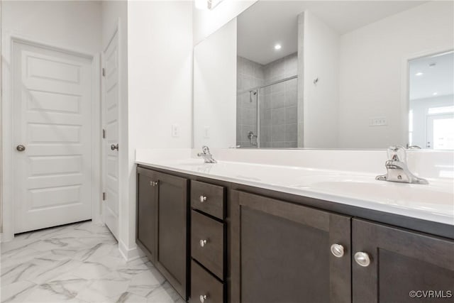 bathroom featuring double vanity, a stall shower, marble finish floor, and a sink