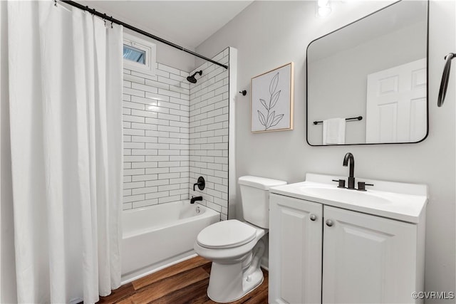 bathroom featuring shower / bath combo, vanity, toilet, and wood finished floors