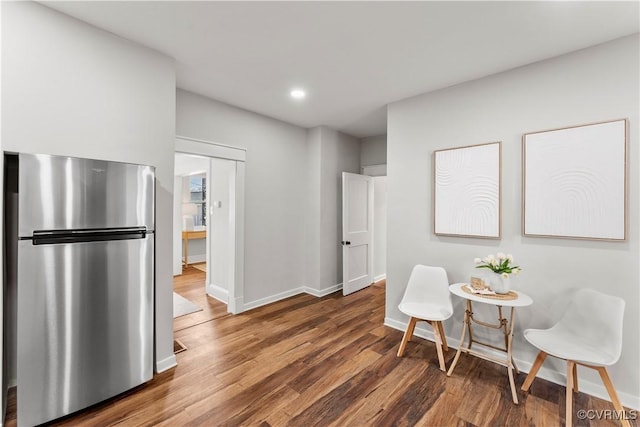 dining room with recessed lighting, baseboards, and wood finished floors