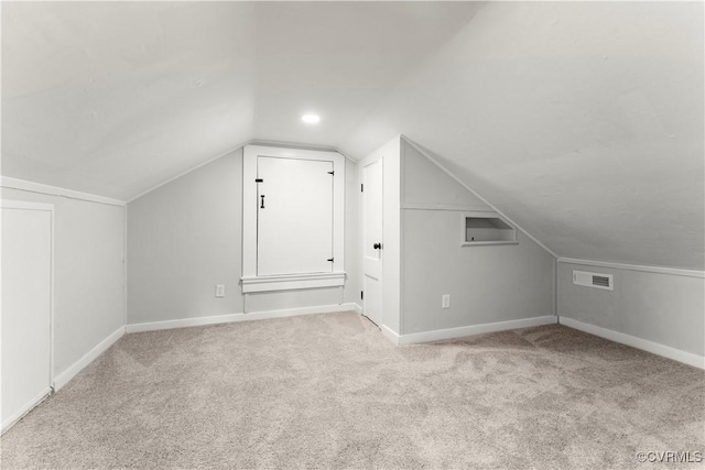 additional living space with lofted ceiling, carpet, visible vents, and baseboards