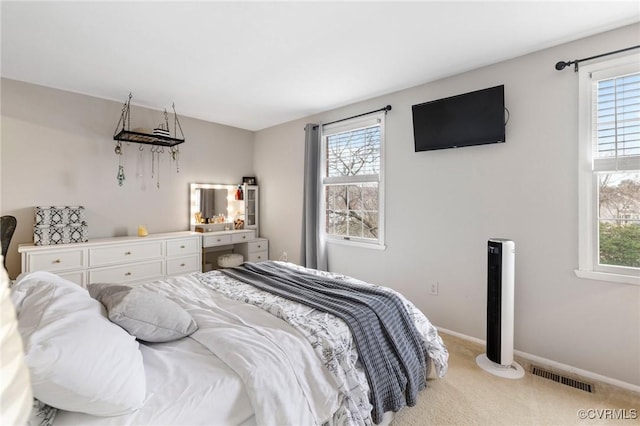 bedroom with multiple windows, visible vents, and carpet flooring