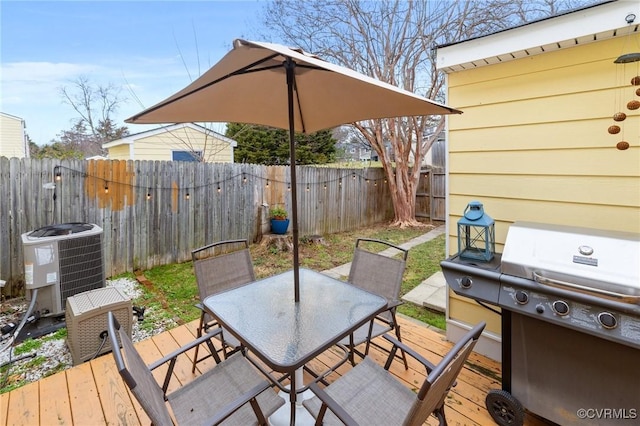 wooden terrace with outdoor dining space, a fenced backyard, a grill, and central air condition unit