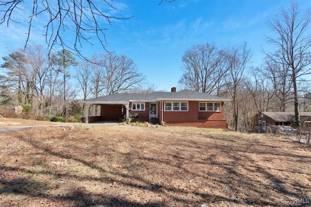 ranch-style house with driveway and brick siding