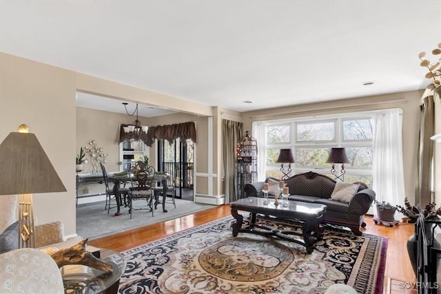 living area featuring a chandelier and wood finished floors