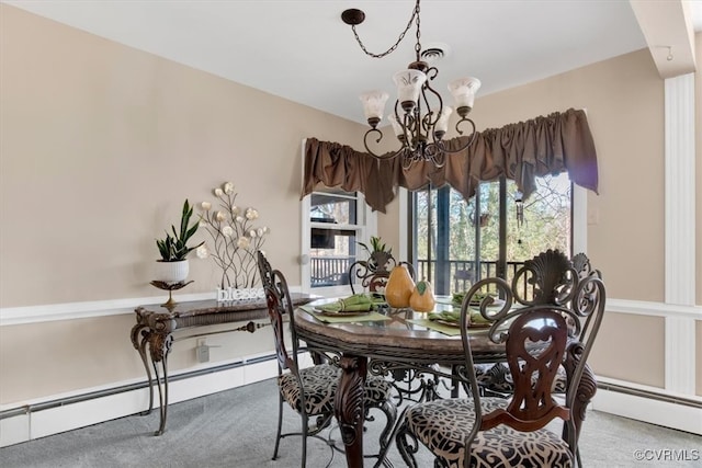 carpeted dining area featuring baseboard heating and a notable chandelier