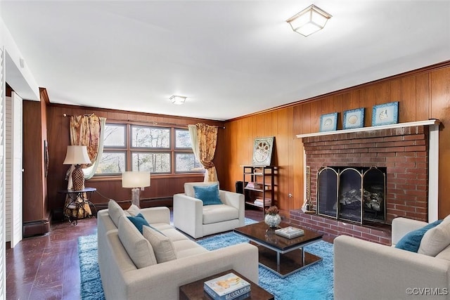 living area with wood walls, a brick fireplace, and wood finished floors