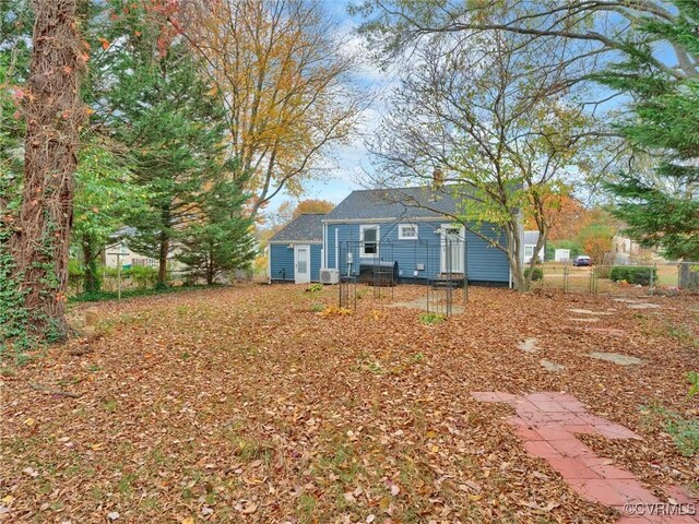 rear view of house featuring fence