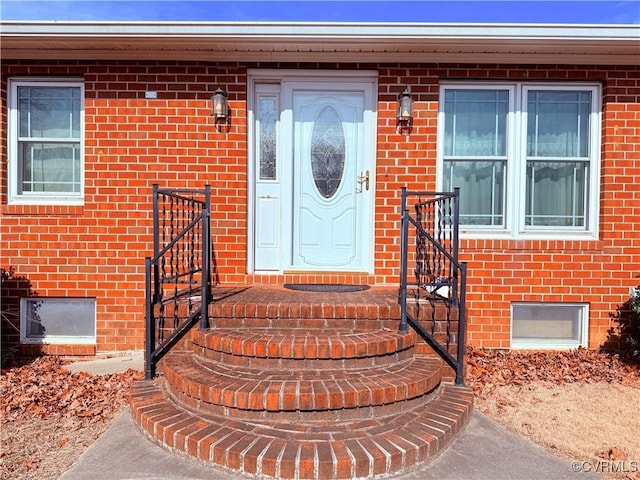 property entrance with brick siding