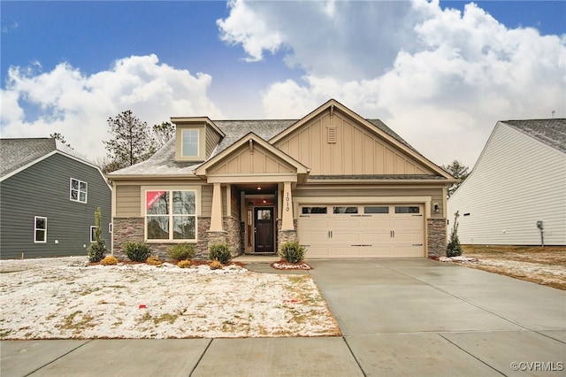 craftsman inspired home featuring a garage, stone siding, board and batten siding, and concrete driveway