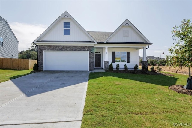 view of front of property with an attached garage, board and batten siding, a front yard, fence, and driveway