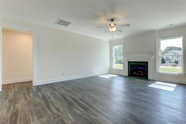 unfurnished living room featuring dark wood-style flooring, a fireplace with flush hearth, visible vents, and baseboards