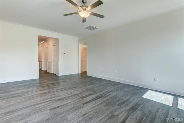 empty room featuring baseboards, visible vents, ceiling fan, dark wood-type flooring, and crown molding