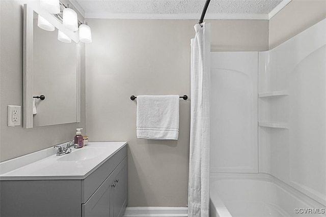 bathroom featuring shower / tub combo with curtain, a textured ceiling, vanity, and baseboards